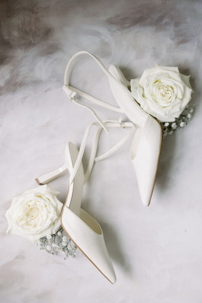 Tupper Manor Wedding | Newport RI Wedding Photographer Brianna Graca Weddings | Fine Art Editorial Imagery at Coastal Mansion Wedding Venues | Flatlay of bridal sandals with white florals