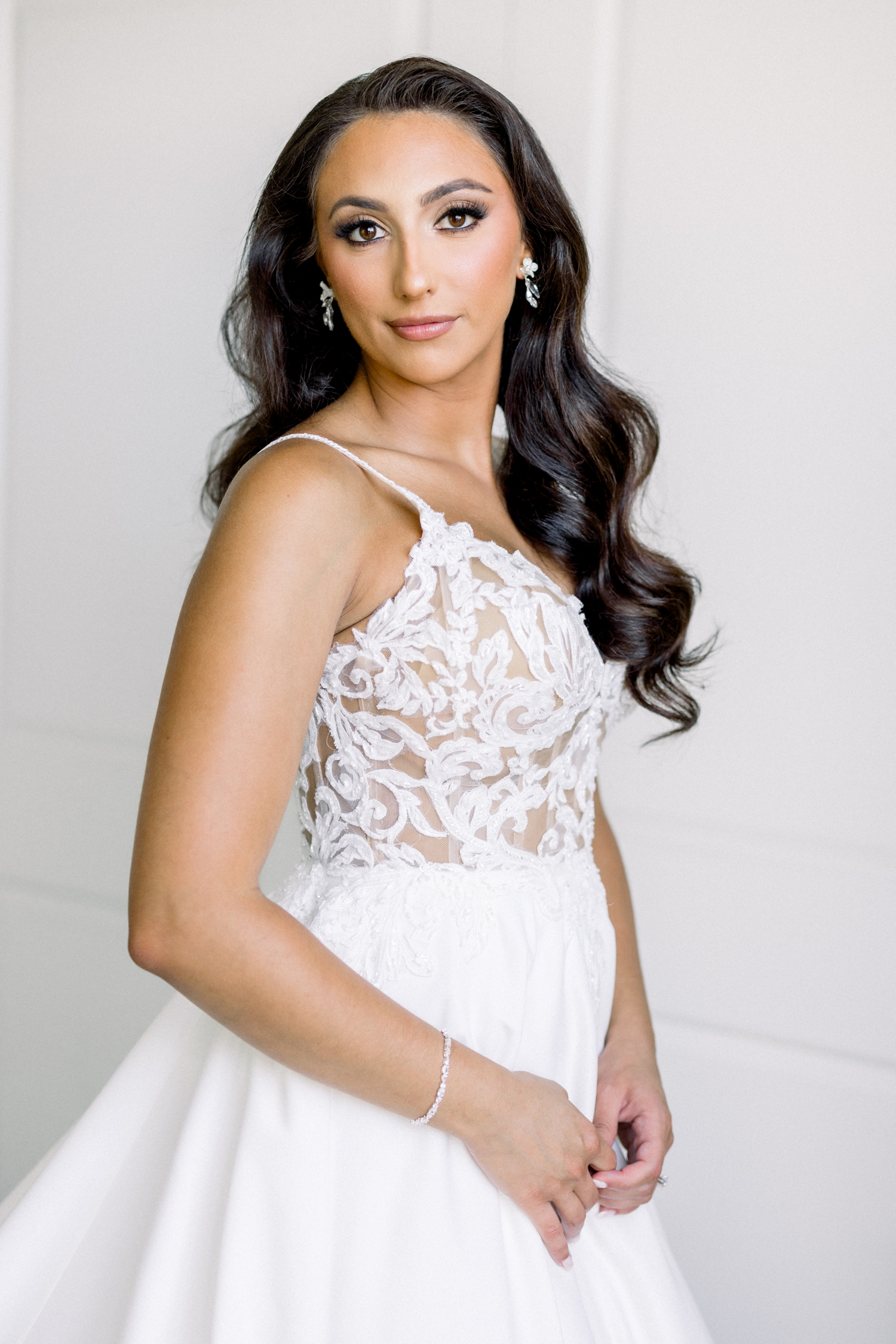 The bride poses in her lace gown before her Newport Harbor Island Resort Wedding.
