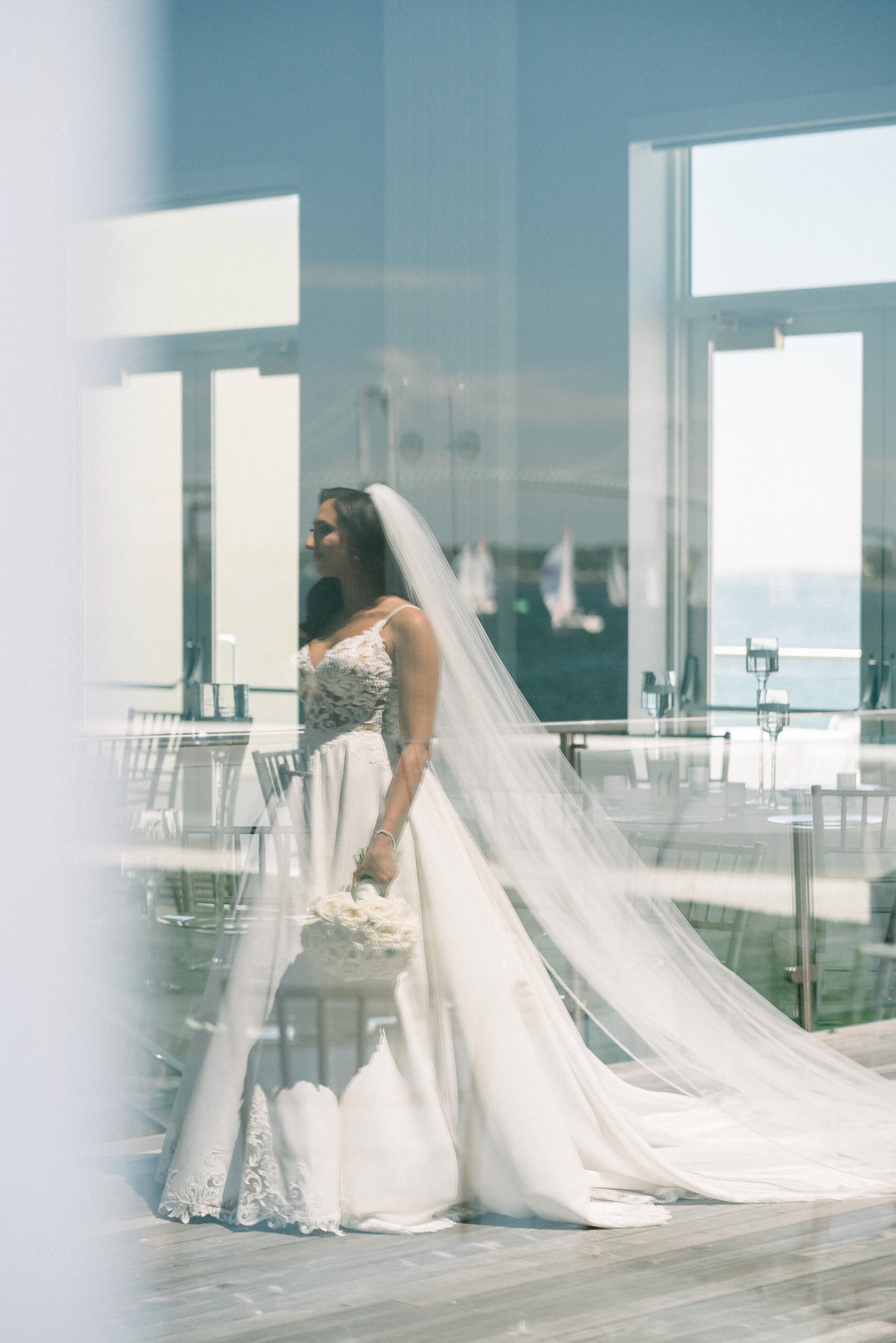 The bride poses in her lace gown before her Newport Harbor Island Resort Wedding.