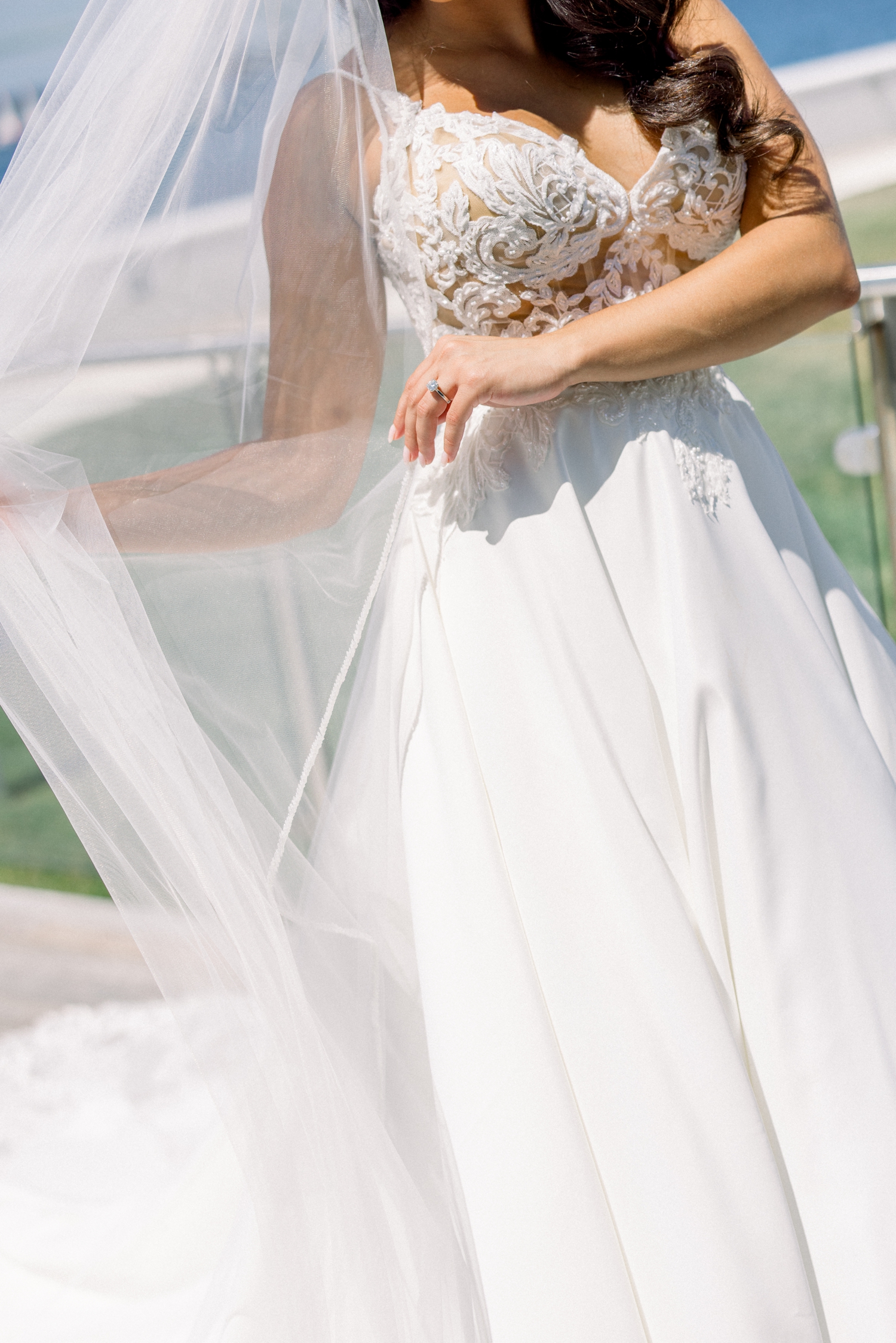 The bride poses in her lace gown before her Newport Harbor Island Resort Wedding.