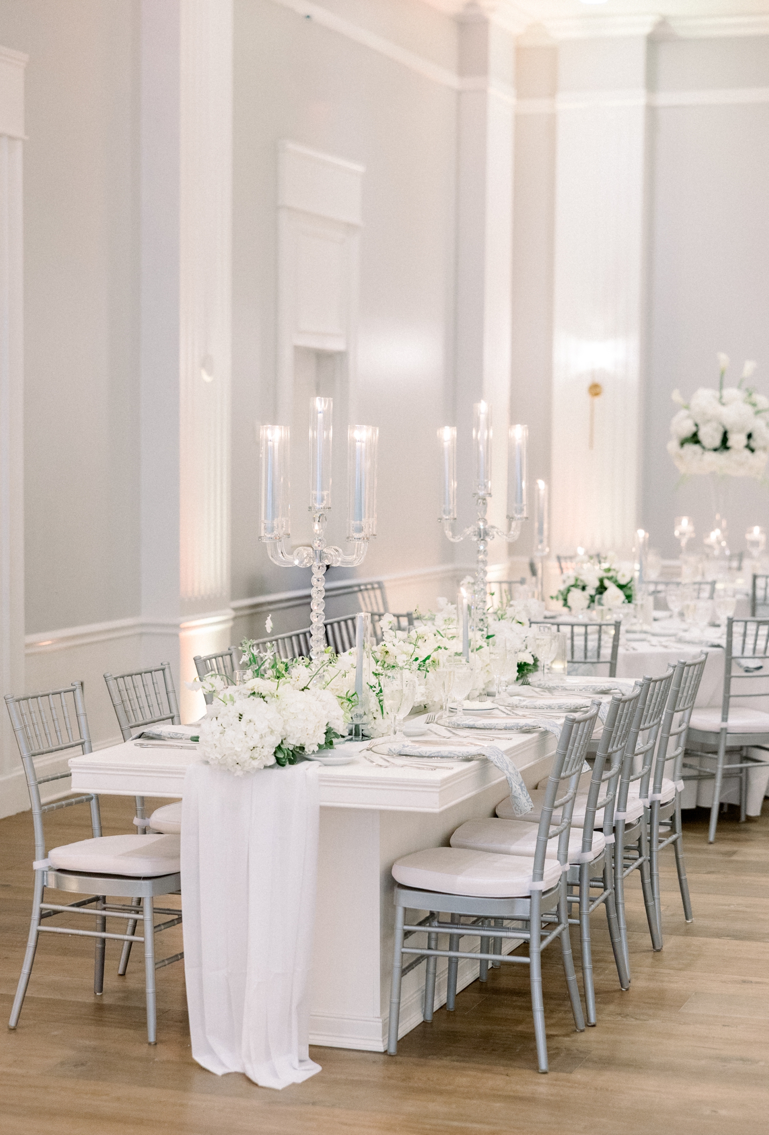 White florals and glass candelabras decorate a Newport Harbor Island Resort Wedding reception.
