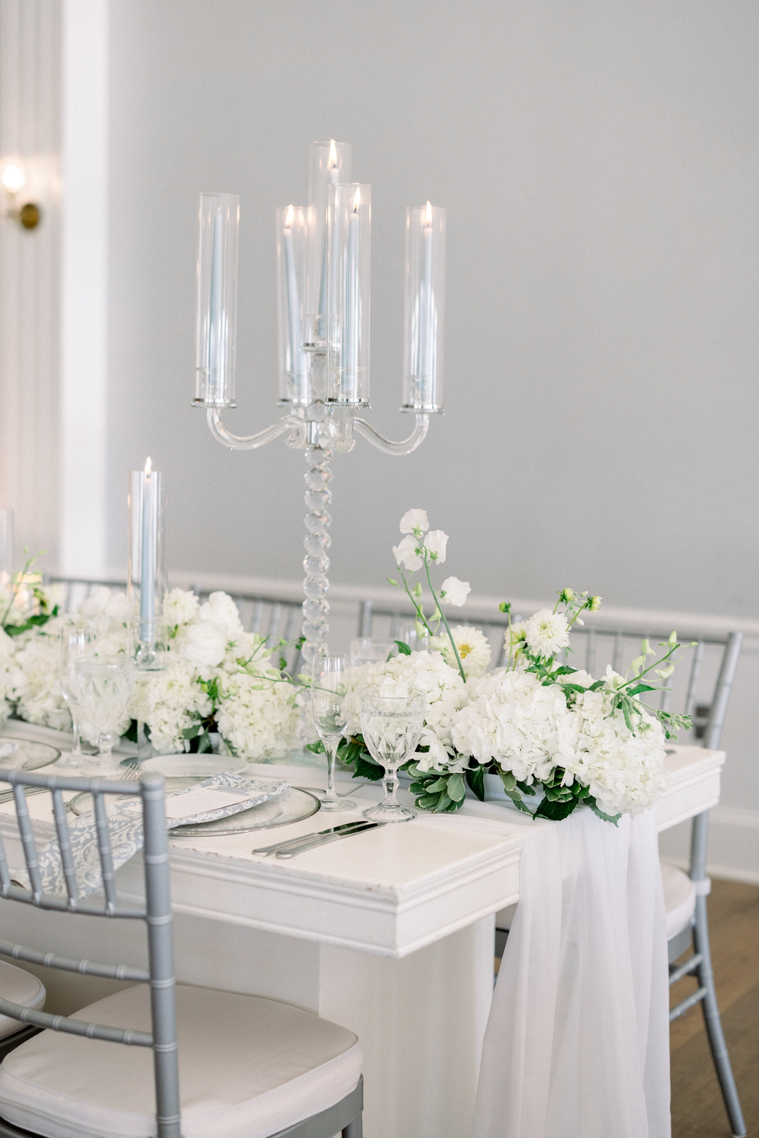 White florals and glass candelabras decorate a Newport Harbor Island Resort Wedding reception.