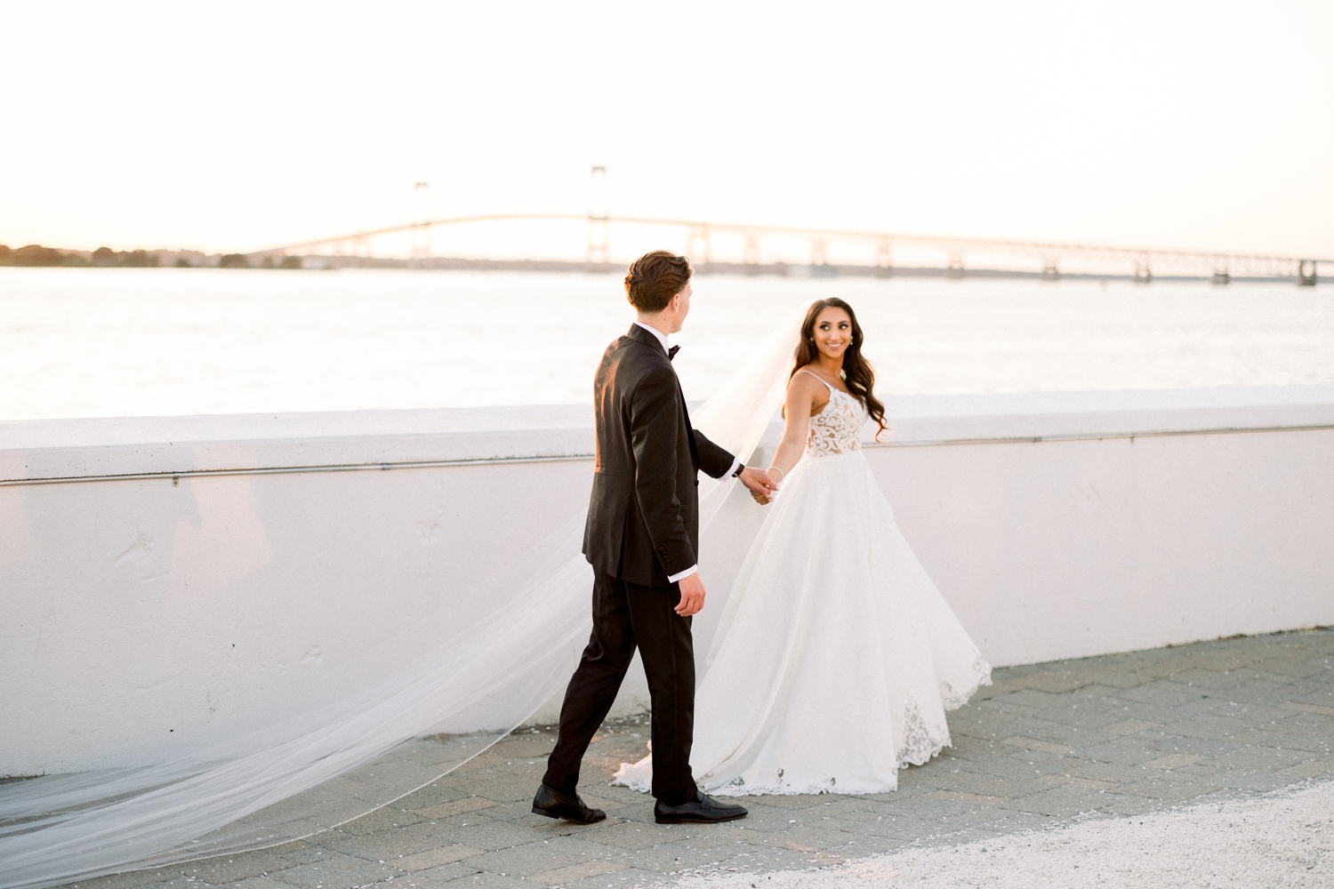 Sunset photos of bride and groom as A coastal black tie celebration unfolds at a Newport Harbor Island Resort Wedding.